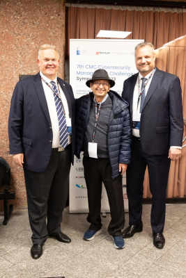 Kim Hildebrant, Professor Emeritus Morris Mottale and Patrick Ghion, State police in Geneva, posing outside the auditorium